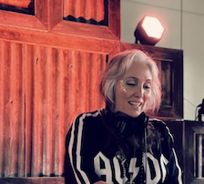 MADSPiN BABY DJing in a vintage band tee at River Sounds Festival 2026